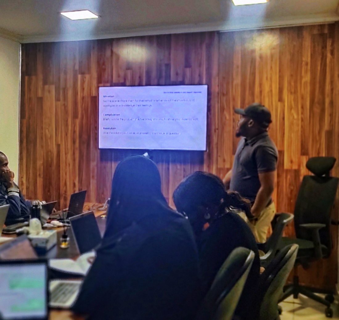 A facilitator leading a training session in a meeting room